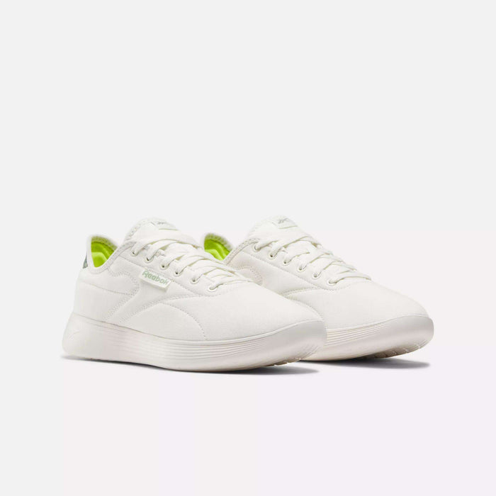 The Reebok Active Lite Shoes feature a minimalist white design with subtle side branding, a hint of lime green on the inner lining, and a 3-D Foam midsole for comfort, shown against a plain white background.