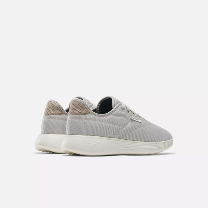 The Reebok Active Lite Shoes are minimalist sneakers in light gray with white soles and beige heel accents, shown side by side on a plain white background.