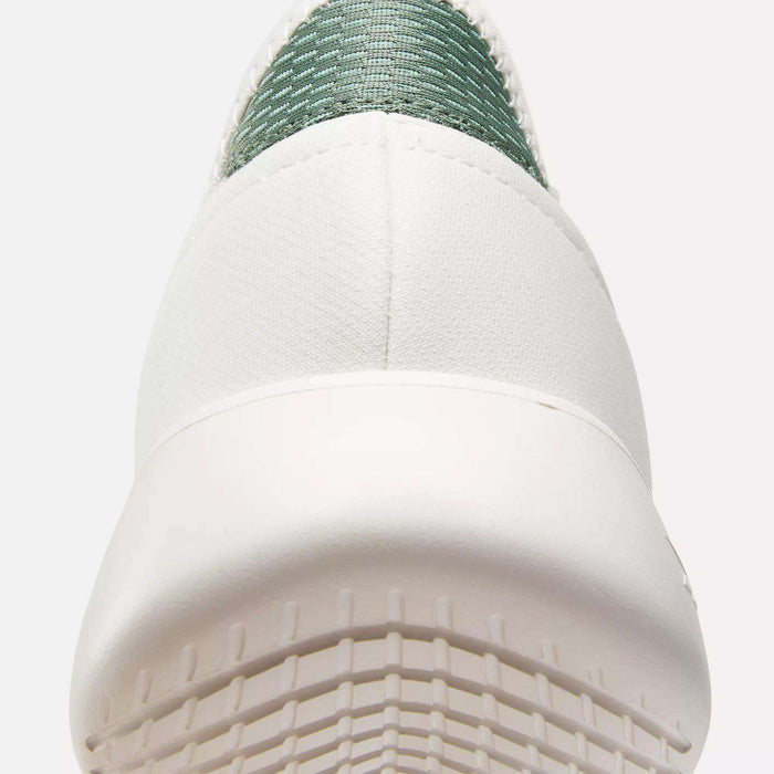 Close-up of the back of a Reebok Active Lite Shoe in white, featuring a textured sole, 3-D Foam midsole, and green woven fabric near the heel.