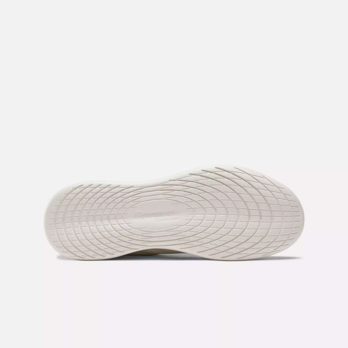 The sole of the Reebok Active Lite Shoes has a textured, wavy pattern with the Reebok logo embossed at the center, capturing the clean and minimalist sneaker style.