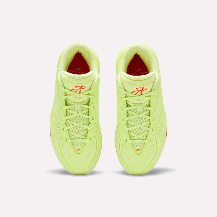 A top-down view of Reebok Angel Reese 1 Shoes - Big Kids in neon yellow-green, featuring textured laces and red logo details on the tongue, shown against a plain light background.