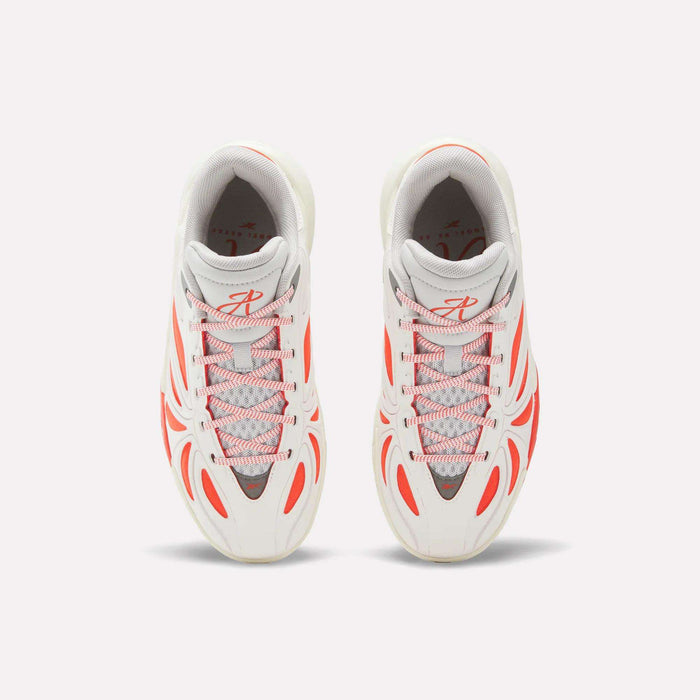 Top view of Reebok Angel Reese 1 Shoes for big kids in white with gray accents and bold orange lines and lace loops, placed side by side on a light background.