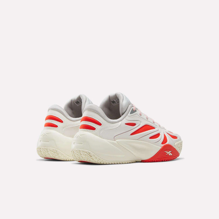 The Reebok Angel Reese 1 Shoes for Big Kids are white performance basketball sneakers with red and gray accents, chunky soles, and a dynamic cutout design, displayed from the back and side on a plain white background.