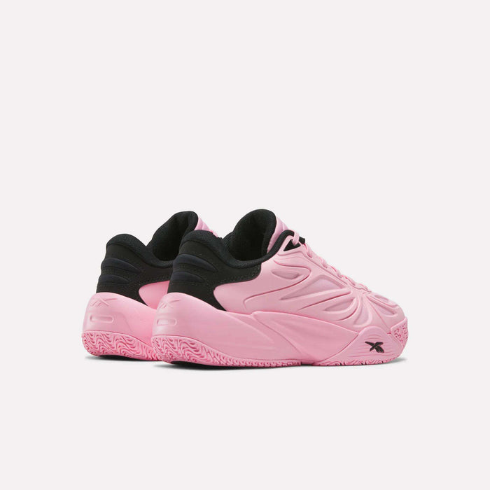 A pair of Reebok Angel Reese 1 Shoes - Big Kids in pink and black, featuring textured pink soles and embossed detailing, are displayed at an angle on a plain white background.
