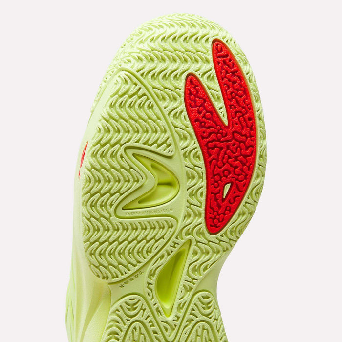 Close-up of the Reebok Angel Reese 1 Shoes – Big Kids, featuring a wavy, textured yellow-green sole with bold red accents and detailed grooves for traction—showcasing signature performance basketball shoe design.