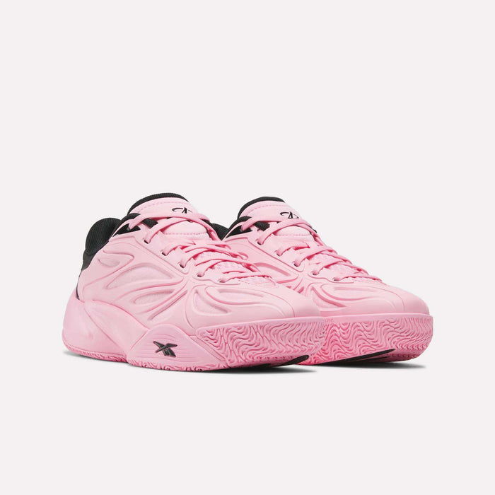 A pair of Reebok Angel Reese 1 Shoes for big kids in light pink with black accents and textured pink soles, positioned side by side on a white background.