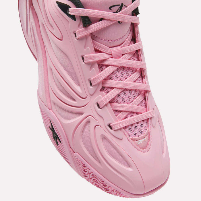Close-up of the Reebok Angel Reese 1 Shoes for big kids—pink athletic sneakers with a textured sole, mesh tongue, and plastic overlays, featuring black lace holes and a small logo on the toe. This stylish design is inspired by kids basketball shoes and offers both comfort and performance.