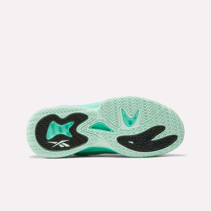 The outsole of the Reebok Angel Reese 1 Basketball Shoes for Big Kids features a mint green base with black traction patterns and a white Reebok logo. Specifically designed as basketball shoes for kids, the sole includes multiple grooves and textures to enhance grip.