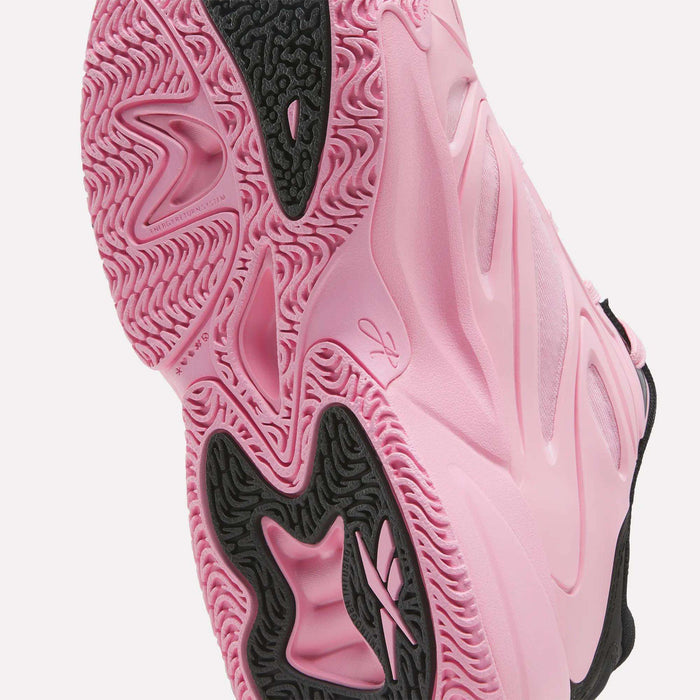Close-up of the pink and black sole of the Reebok Angel Reese 1 Shoes for big kids, showcasing textured patterns, grooves, and a visible Reebok logo—highlighting the shoe’s grip and standout design details. Perfect for young players seeking performance and style in their basketball shoes.