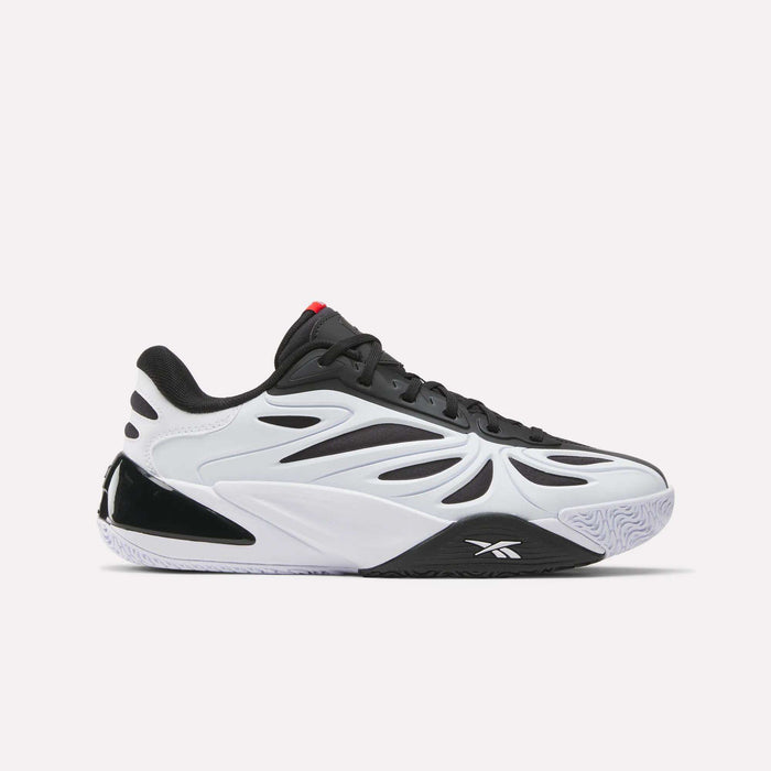 The Reebok Angel Reese 1 Basketball Shoes are modern low-top sneakers with a white and black wavy design, black laces, a textured white sole, red tongue accents, and the Reebok logo on the side.