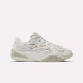 The Reebok Angel Reese 1 Basketball Shoes are light beige and white low-tops with wavy textured sides, a textured rubber sole, and Energy Return System for comfort—shown on a plain white background.