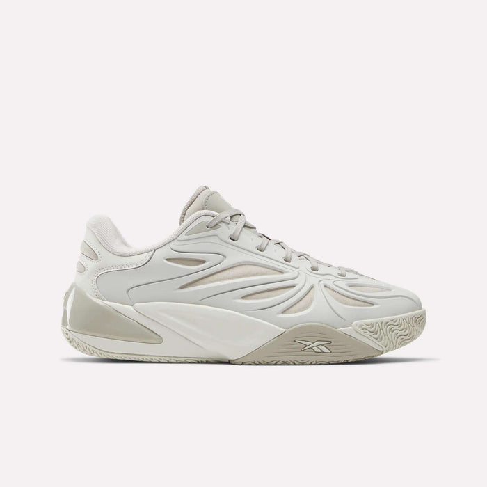 The Reebok Angel Reese 1 Basketball Shoes are light beige and white low-tops with wavy textured sides, a textured rubber sole, and Energy Return System for comfort—shown on a plain white background.