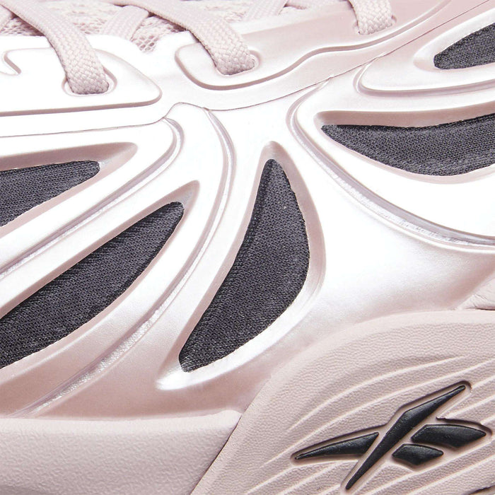 Close-up of a light pink Angel Reese 1 Basketball Shoe by Reebok, featuring sculpted raised details, black mesh underlays, a visible Reebok logo, and the Energy Return System inspired by performance basketball shoes.