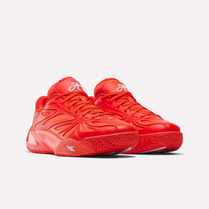 A pair of vibrant red Reebok Angel Reese 1 Basketball Shoes, featuring textured soles, intricate side patterns, and white branding on the tongue and side, displayed against a plain light background.