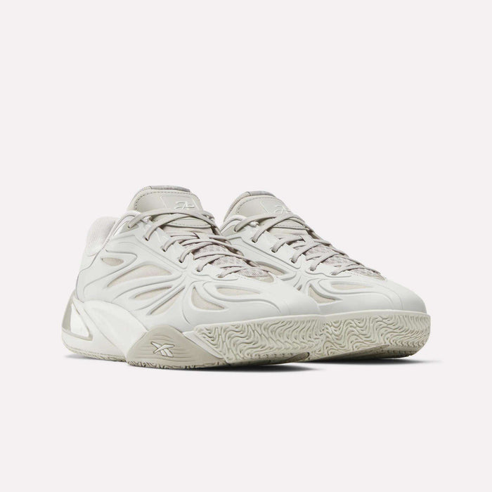 The Reebok Angel Reese 1 Basketball Shoes feature a modern design in light gray with wave-like side patterns, textured soles, and laces, inspired by Angel Reese and showcased against a plain white background.