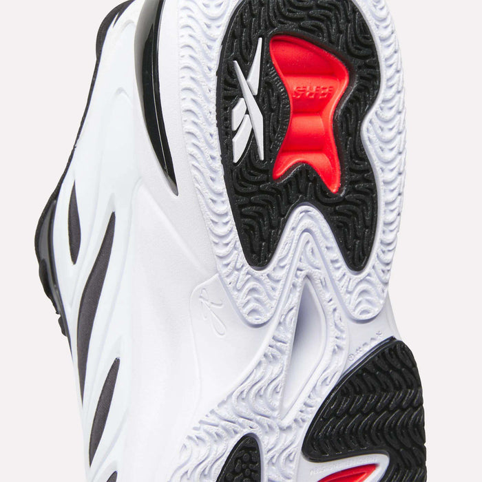 Close-up of the sole of the Reebok Angel Reese 1 Basketball Shoes, showing a wavy black and white pattern with red accents, visible Reebok logo, and grip-enhancing grooves powered by the Energy Return System.