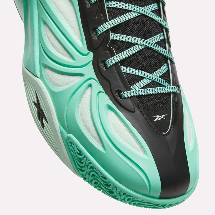 Close-up of a turquoise and black Angel Reese 1 Basketball Shoe with intricate laces, mesh fabric, and a textured sole, showcasing the Reebok logo on the side and tongue. Designed for peak performance basketball enthusiasts, this model features the advanced Reebok Energy Return System for enhanced cushioning and support on the court.