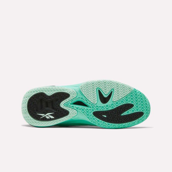 The sole of the Reebok Angel Reese 1 Basketball Shoe is displayed, featuring a wavy traction pattern in black and mint green, with the Reebok logo positioned near the heel. Engineered with the Reebok Energy Return System for optimal comfort and support, this model showcases features typical of high-performance basketball footwear.