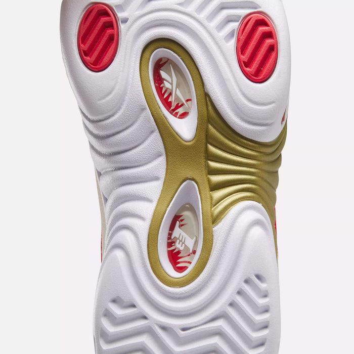 Close-up of the outsole of the Reebok Answer III Basketball Shoes, showing wavy white, red, and gold patterns with circular cutouts. The visible tread texture highlights the unique retro design.