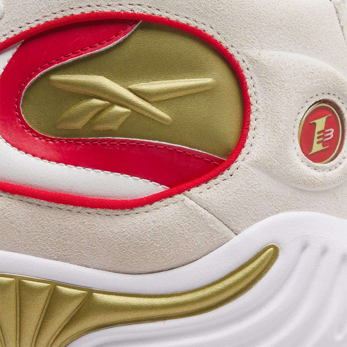 Close-up of the Reebok Answer III Basketball Shoes, featuring a gold Reebok logo, red and gold accents, white midsole, and an embossed circular emblem with a red 3 on light suede—an iconic Allen Iverson style.