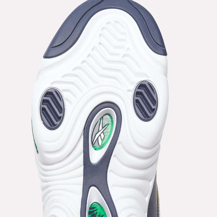 Close-up of the Answer III Shoes’ sole by Reebok, showing a white base with green and black accents, wavy tread, and the Reebok logo — a retro design inspired by Allen Iverson’s era — visible through a transparent section.