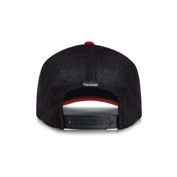 The Reebok Athlete Cap is a black mesh baseball cap seen from the back, featuring an adjustable snapback closure and a small Reebok logo tag above the opening.