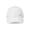 The Reebok Badge Cap is a plain white adjustable sports cap with visible stitching, a curved brim, and a small light gray embroidered logo on the front left side, shown from the front against a white background.