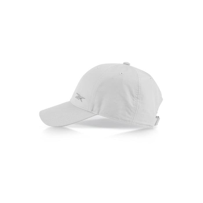 The Reebok Badge Cap is a plain white adjustable sports cap with a curved brim, ventilation holes on top, and a subtle front-left logo. Shown against a white background.