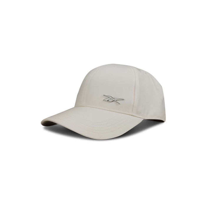 The Reebok Badge Cap is a beige baseball cap with a curved brim and an embroidered Reebok logo on the front, shown against a white background.