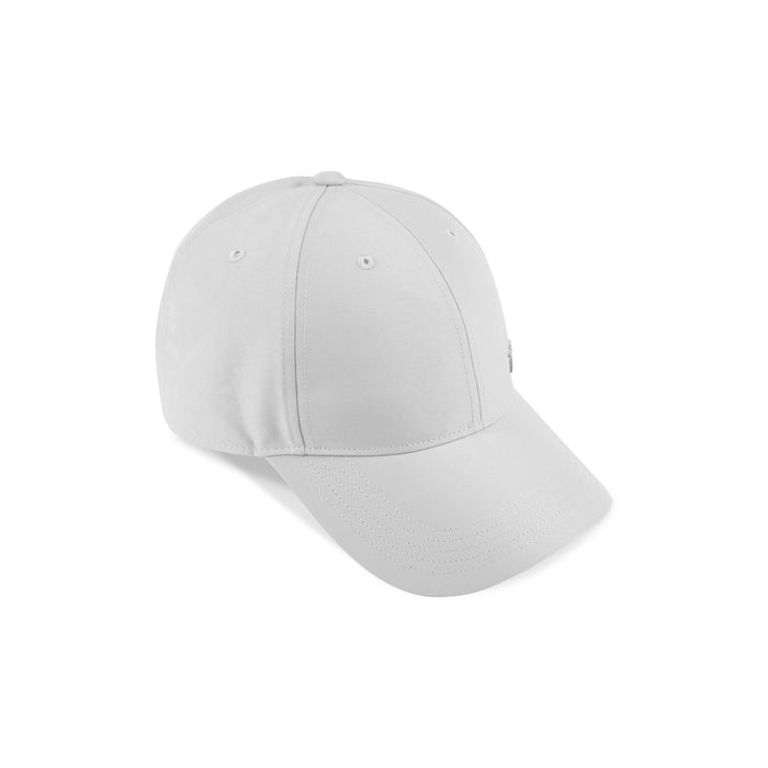 The Reebok Badge Cap is a plain white adjustable sports cap with a curved brim, shown at an angle on a white background, offering comfort and style.