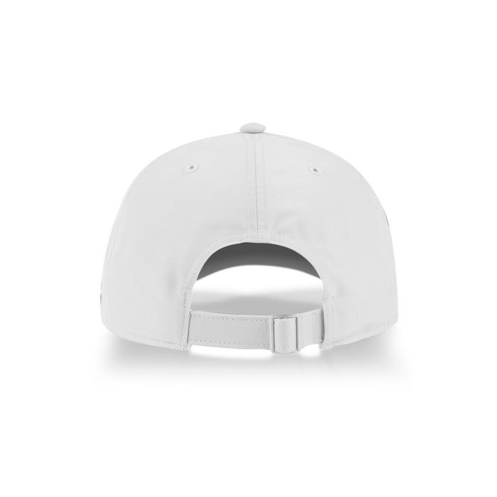 A Reebok Badge Cap in white is shown from the back, highlighting its adjustable strap and curved rear opening. The sports cap rests on a white surface with a subtle shadow below.