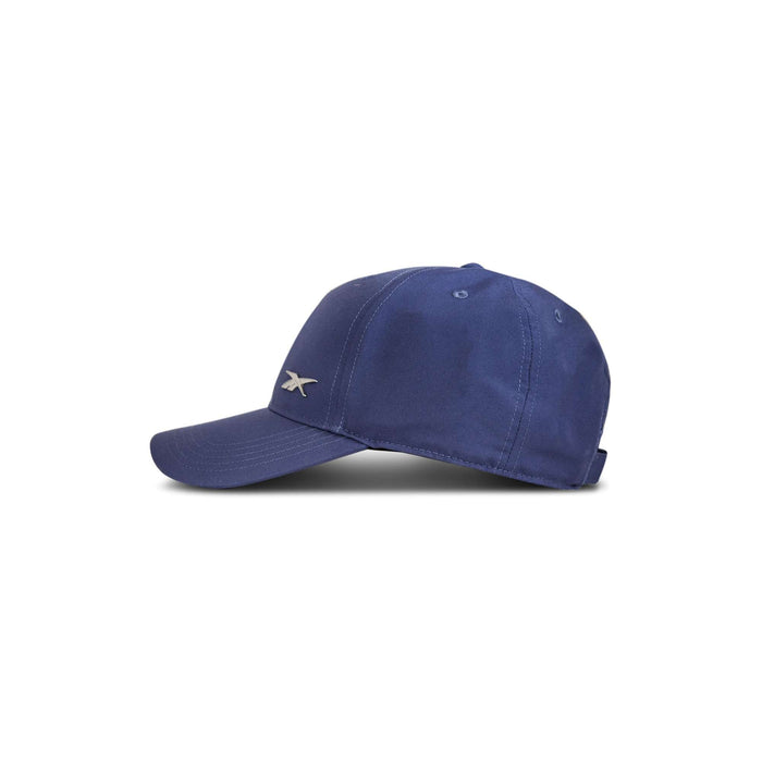 The Reebok Badge Cap, in navy blue with a small silver logo on the side, is displayed against a white background.