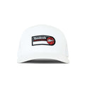 The Reebok Basketball Trucker Cap is a white snapback hat with a curved brim, featuring a logo patch and red basketball graphic on the front, perfect for adding sporty style to any look.
