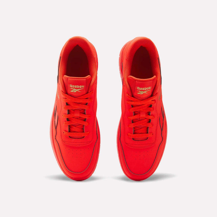 Top view of a pair of BB 1000 Retro Basketball Shoes by Reebok in bright red, featuring laces and the Reebok logo on the tongue and side, set against a plain white background for that classic throwback court style.