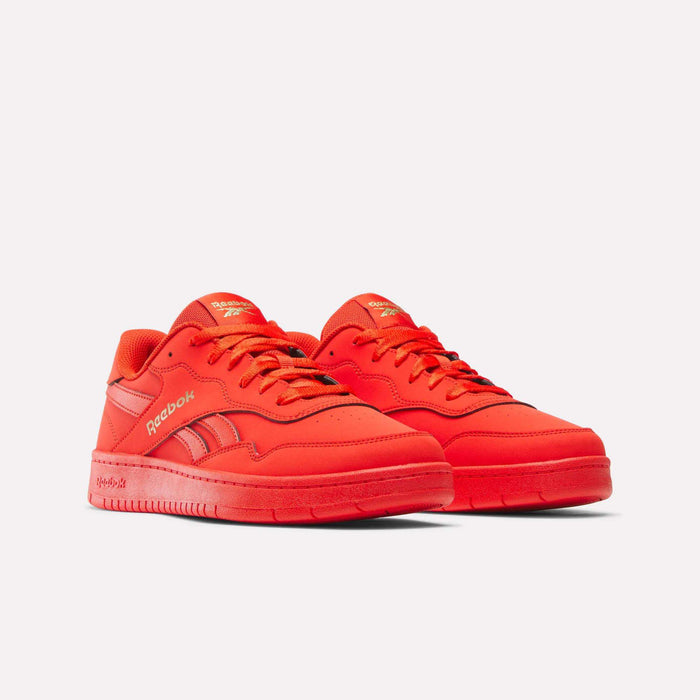 A pair of Reebok BB 1000 Retro Basketball Shoes in vivid red with gold logos, displayed against a plain white background. These low-cut sneakers feature matching red soles, laces, and stitching, capturing classic court-inspired style.