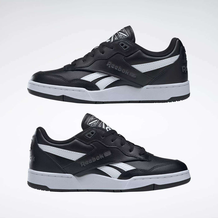 The Reebok BB 4000 II Shoes are black with white accents and grey soles, shown from the side against a plain light background. The Reebok logo appears on both the side and heel of each shoe.