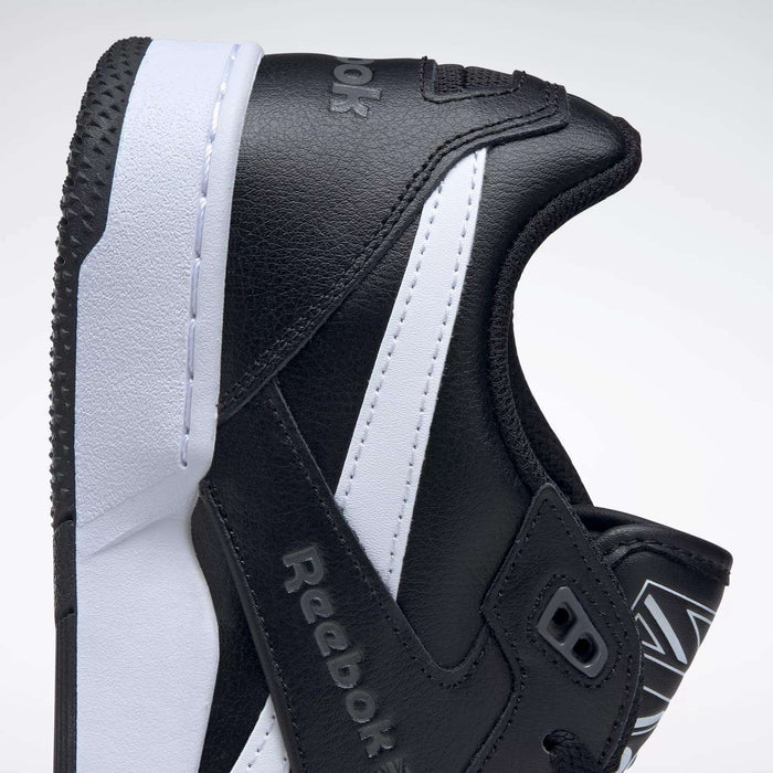 Close-up of the Reebok BB 4000 II Shoes, showing the side profile with the Reebok logo. These basketball-inspired sneakers feature a black leather upper, white midsole, and black outsole against a plain background.