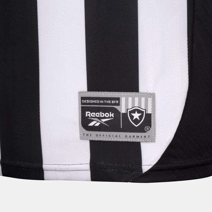 A close-up of the Botafogo Men's Home Jersey by Reebok features black and white stripes, the Reebok logo, and the Botafogo club badge on a rectangular patch near the bottom.