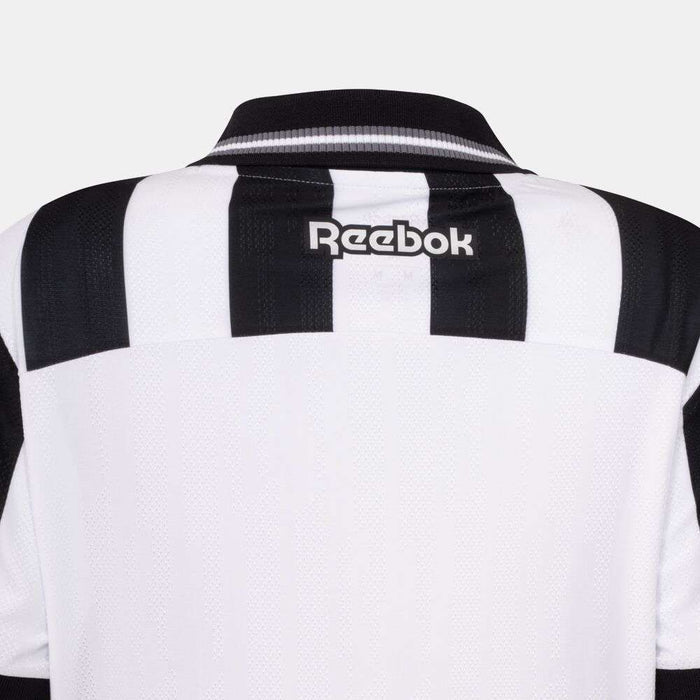 Back view of the Botafogo Women's Home Jersey by Reebok, showing black and white stripes, a black collar, and a white Reebok logo on the upper back.