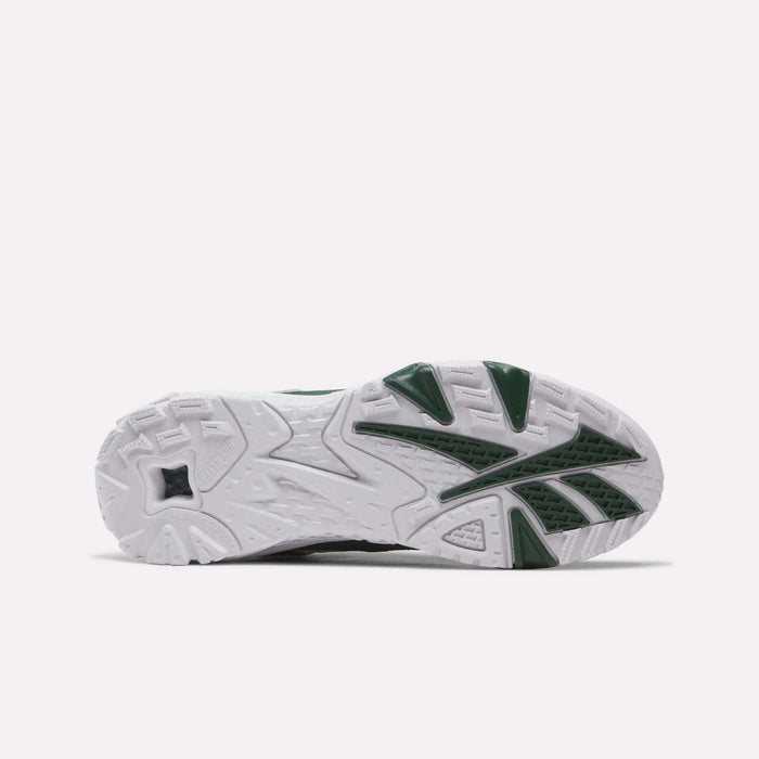 The image displays the bottom view of the Brutus Low Shoes by Reebok, showcasing a white sole with textured patterns and dark green accents on the tread—reflecting classic Reebok heritage style. The design draws inspiration from 90s sneakers, while a lightweight EVA midsole ensures comfort with every step.