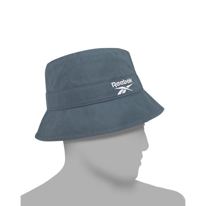 A Reebok Bucket Hat in grey from the [REE]CYCLED Collection, made with recycled nylon and featuring a white embroidered logo on the front, is shown displayed on a featureless grey mannequin head against a plain white background.