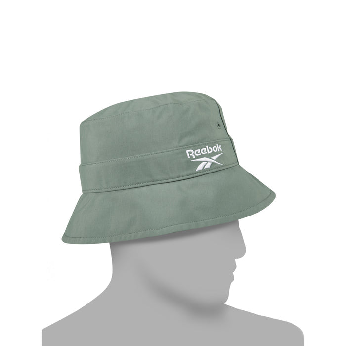 The Reebok Bucket Hat in sage green is crafted from recycled nylon and features a white embroidered logo on the side, shown in profile on a gray mannequin head against a plain white background.