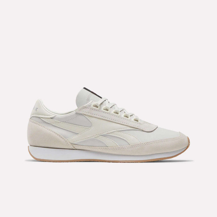 A side view of Reebok Camargue Shoes in white and beige showcases a low-profile, lace-up design with a slightly raised sole, subtle stitching, and minimalist detailing for timeless style.