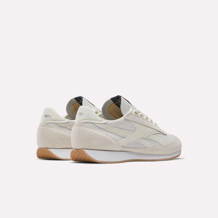 A pair of Reebok Camargue Shoes with off-white suede and leather panels, white midsoles, light brown textured outsoles, and grey branding are displayed on a white background.