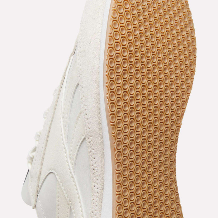 Close-up of Reebok Camargue Shoes in white, featuring a honeycomb-patterned gum sole that highlights the premium leather design and detailed craftsmanship of this luxury archive trainer.
