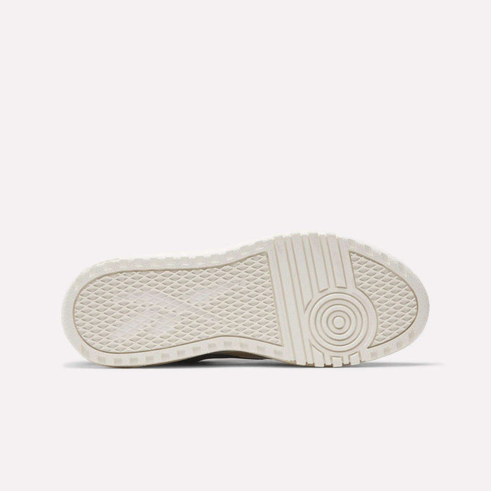 The image displays the white sole of Reebok Campio Extra Women's Shoes, viewed from below. The sole features a textured tread pattern with concentric circles and grid-like designs for added grip against a plain light background.