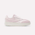 The Campio XT Double Shoes - Big Kids by Reebok are light pink retro low-tops with white laces, subtle branding, and a thick white sole—perfect for girls' collections and shown in profile against a plain white background.