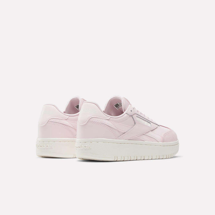 The Reebok Campio XT Double Shoes for big kids, in light pink and white, are shown on a white background from a back and side angle to showcase the heels and sides—putting a modern spin on classic retro style.