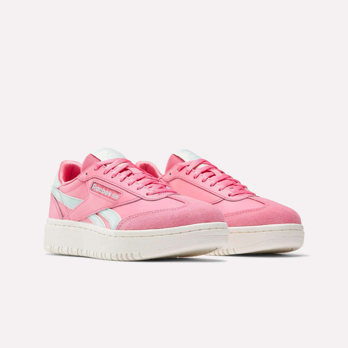 The Reebok Campio XT Double Shoes for big kids feature a pink retro design with white accents and thick white soles, shown against a plain light background.