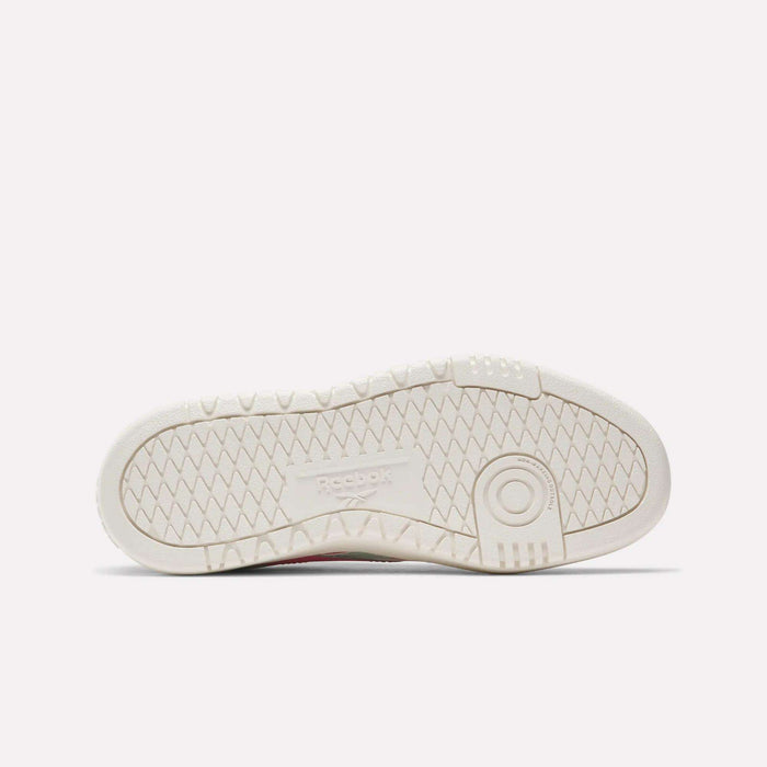The image shows the sole of a white Reebok Campio XT Double Shoe for big kids, featuring a textured zigzag tread pattern and an embossed Reebok logo—ideal for fans of classic retro sneakers.